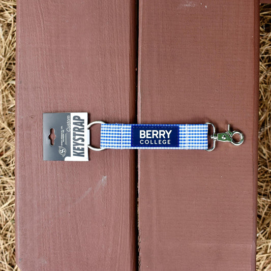 key strap with an O ring and clip with a blue and white gingham pattern and a rubber patch that says berry college