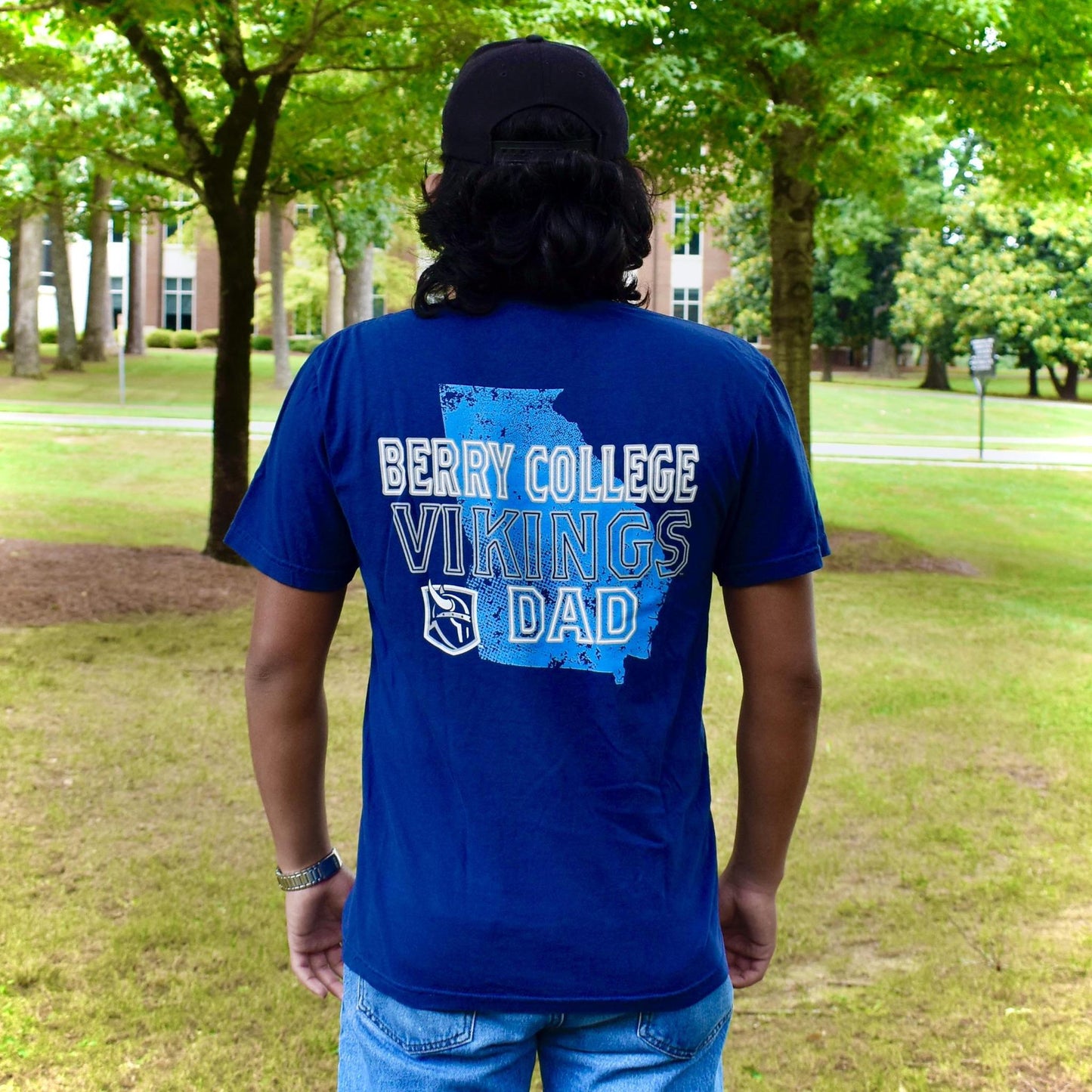 The back of a t shirt with "Berry college Vikings Dad" and the viking head logo layered on top of a distressed Georgia state outline