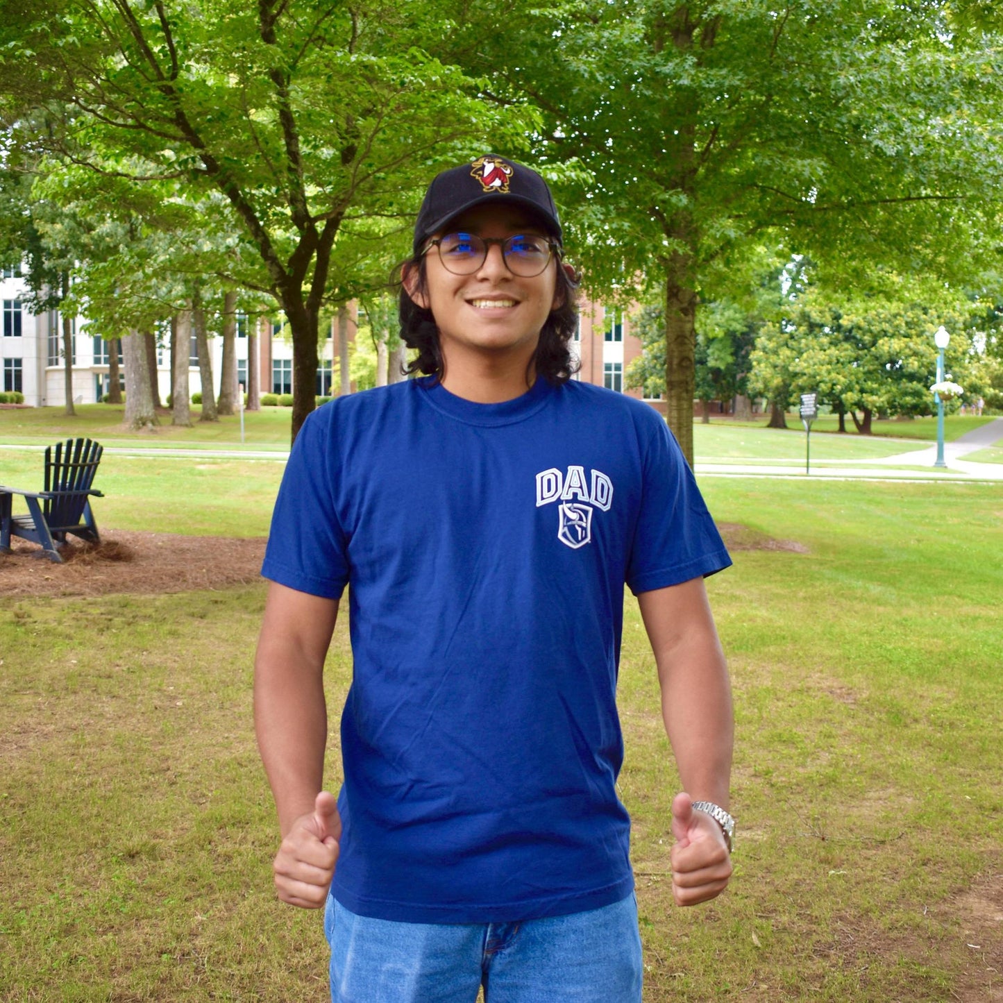 Man wearing navy shirt with design on the right chest with the word "Dad" arched above a viking head logo